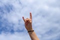 hand of a girl making the sign of horns with her fingers