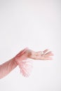 Hand of a girl in a pink lace dress with frills on a white background raised up Royalty Free Stock Photo