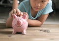 Hand girl put coin to piggy bank, saving money Royalty Free Stock Photo