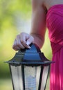 Hand of a girl in a red dress on a street lamp Royalty Free Stock Photo