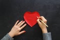 Hand of girl writing love letter on Valentine Day. Royalty Free Stock Photo