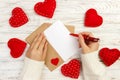 Hand of girl writing love letter on Valentine Day. Handmade postcard. Woman write on postcard for 14 February holiday celebration. Royalty Free Stock Photo