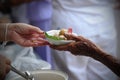 Hand give food to hands of a beggar Royalty Free Stock Photo