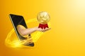 Hand gives a gold medal through the smartphone screen on a yellow background. Concept for online reward, reschedule sports, stay