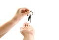 Hand gives keys to hand on white background Royalty Free Stock Photo
