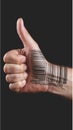 Hand gives thumbs up with a barcode printed on the back Royalty Free Stock Photo