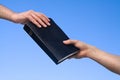 Hand Giving Bible Royalty Free Stock Photo