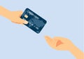 Hand giving a credit card to other hand.