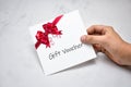 Hand Giving Gift Voucher Card. Holding Prepaid Coupon