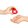 Hand giving heart with red cross symbol Royalty Free Stock Photo