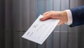 Hand giving paycheck, check, cheque Royalty Free Stock Photo
