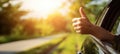The hand giving a thumbs up from a car window in a scenic drive AI generated image Royalty Free Stock Photo