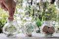 Hand and Glass jar piggy bank with coins. Plan your savings, run a growing business for success and save for retirement Royalty Free Stock Photo