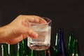 Hand with a glass of water and effervescent tablet of hangover on a dark background. Royalty Free Stock Photo