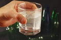 Hand with a glass of water and soluble tablet of a hangover on dark background. Royalty Free Stock Photo