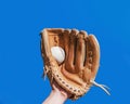 Baseball leather glove with white ball on hand Royalty Free Stock Photo