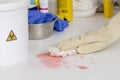 cleaning a spilled liquid next to a container for biological risk