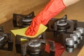 Hand in Glove Cleaning Stove Top with Microfiber Cloth Royalty Free Stock Photo