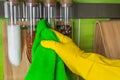 Hand in glove with green rag is wiping spice bottles Royalty Free Stock Photo