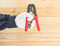 Hand in glove hold wire stripper Royalty Free Stock Photo