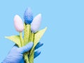 Hand in glove holding flowers fabric. Anti-allergic Royalty Free Stock Photo