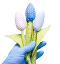 Hand in glove holding flowers made of fabric. Anti-allergic Royalty Free Stock Photo
