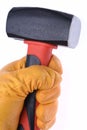 Hand with glove holding hammer Royalty Free Stock Photo