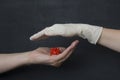 Hand without a glove holds dangerous red coronavirus, hand in white medical disposable rubber latex glove closes, destroys virus, Royalty Free Stock Photo