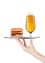 Hand with glove holds tray with burger and beer