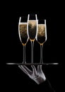 Hand with glove holds tray with champagne glasses Royalty Free Stock Photo