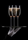 Hand with glove holds tray with champagne glasses Royalty Free Stock Photo