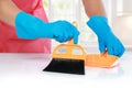 Hand with glove using cleaning broom to clean up Royalty Free Stock Photo