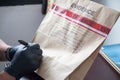 Hand in glove writing on evidence bag and seal by red tape in cr Royalty Free Stock Photo