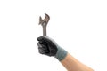 Hand of a gloved man holding a wrench. Isolated white background Royalty Free Stock Photo