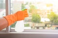 Hand in gloves cleaning window with rag and cleanser spray at ho Royalty Free Stock Photo