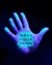 Hand Glowing With Ultra Violet Light Showing Viruses Royalty Free Stock Photo