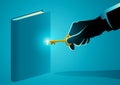 Hand with golden key opening a book Royalty Free Stock Photo
