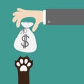 Hand golding money bag with dollar sign. Dog cat paw print taking gift. Adopt, donate, help, love pet animal. Helping hand concept Royalty Free Stock Photo