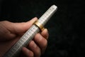 Hand of a goldsmith measures a golden ring on a sizer gauge, je Royalty Free Stock Photo