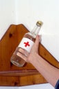 Alcohol bottle, symbol for alcoholism and drinking problem