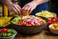 hand grating cheese over taco salad