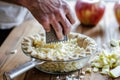 hand grating fresh apple for a pie filling Royalty Free Stock Photo