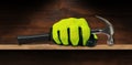 Hand with Protective Work Glove Holding an Old Steel Hammer Royalty Free Stock Photo