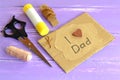 Hand greeting card with message I love dad. Scissors, glue, cord, thread, needle. Craft inspirations for kids