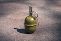 Hand grenade RGD-5 on asphalt. abandoned lost pomegranate green on the pavement. fragmentation grenade