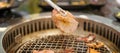 Hand Grilling meat pork on stove serve in restaurant. Japanese food and Korean BBQ traditional style Royalty Free Stock Photo