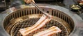 Hand Grilling meat pork on stove serve in restaurant. Japanese food and Korean BBQ traditional style Royalty Free Stock Photo