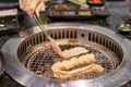 Hand Grilling meat pork on stove serve in restaurant. Japanese food and Korean BBQ traditional style Royalty Free Stock Photo