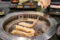 Hand Grilling meat pork on stove serve in restaurant. Japanese food and Korean BBQ traditional style Royalty Free Stock Photo