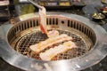 Hand Grilling meat pork on stove serve in restaurant. Japanese food and Korean BBQ traditional style Royalty Free Stock Photo